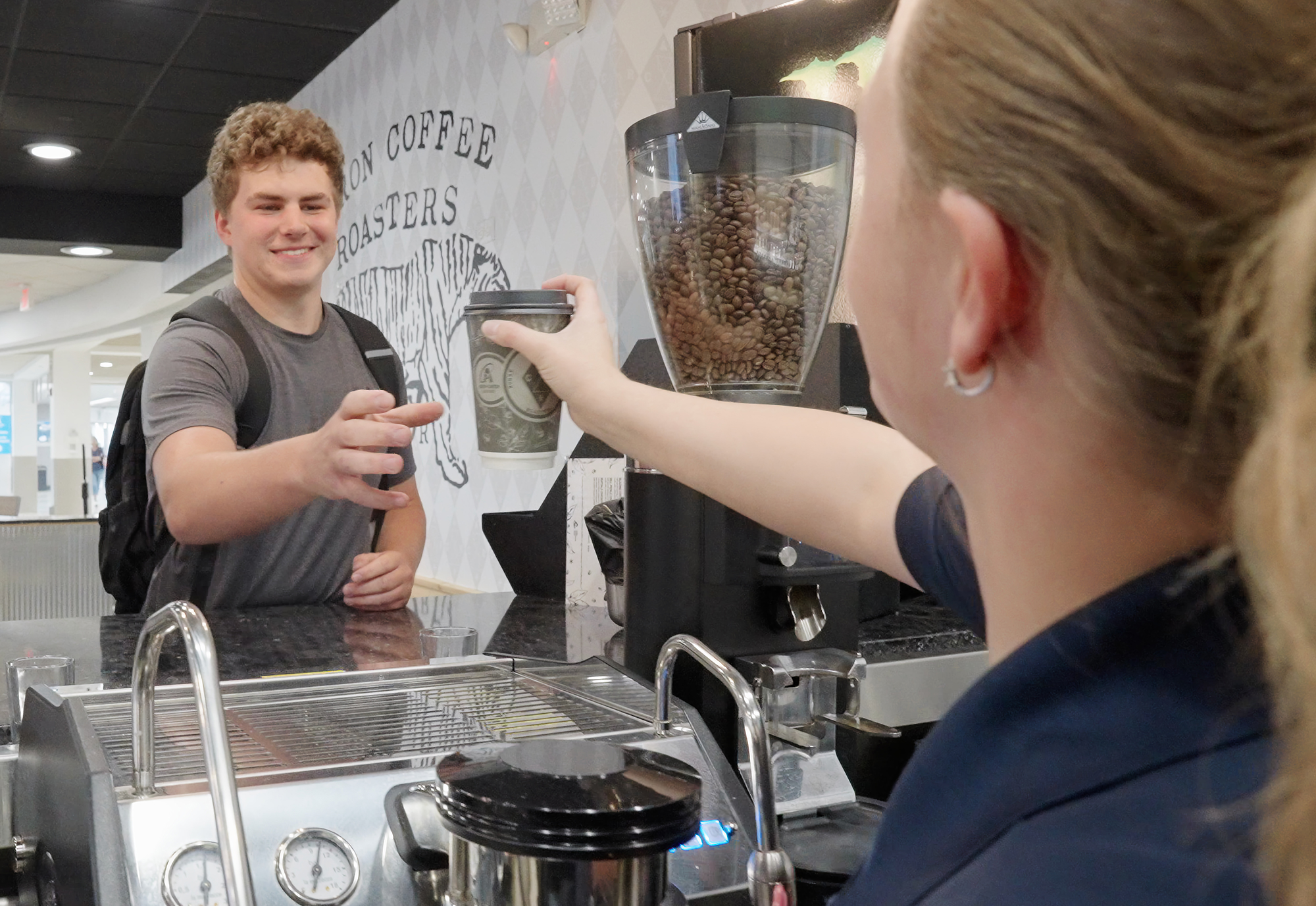 young man buying coffee