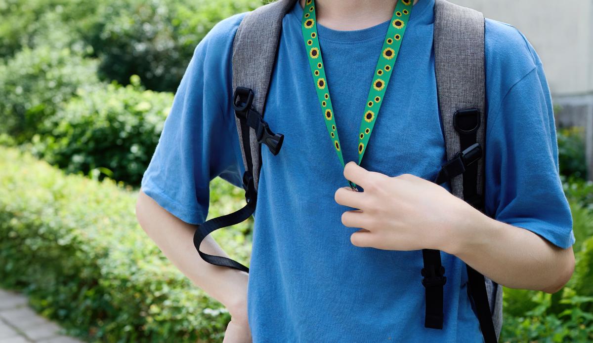young man with sunflower lanyard